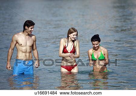 One male and two female young adults in the sea View Large Photo Image Picture - One male and two female young adults in the sea. Fotosearch