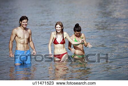 One male and two female young adults in the sea View Large Photo Image Stock Image - One male and two female young adults in the sea. Fotosearch