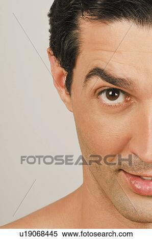 Stock Photography - One side of young male adult face. Fotosearch