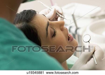Stock Image - Patient at the dentist. Fotosearch