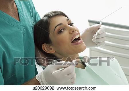Stock Image - Patient at the dentist. Fotosearch