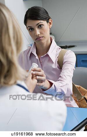 Patient taking medicine from doctor View Large Photo Image Stock Photo - Patient taking medicine from doctor. Fotosearch