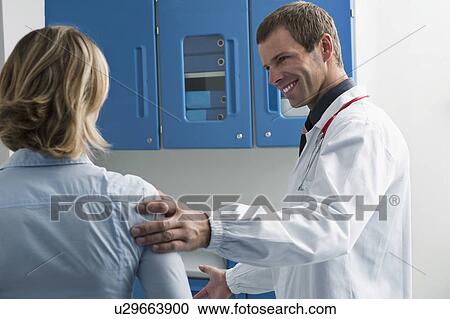 Stock Image - Patient visiting doctor. Fotosearch