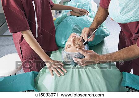 Surgeon marking incision lines on face in operating room View Large Photo Image Stock Image - Surgeon marking incision lines on face in operating room. Fotosearch
