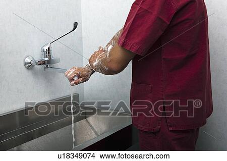Picture - Surgeon scrubbing hands. Fotosearch