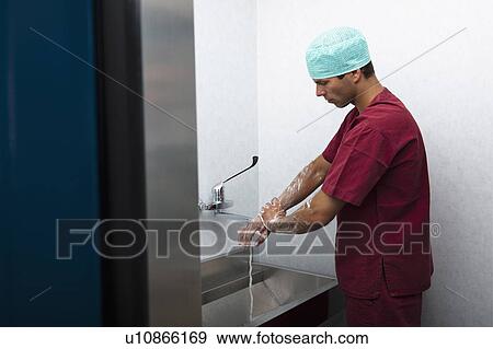 Stock Photo - Surgeon scrubbing hands. Fotosearch