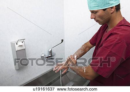 Stock Photo - Surgeon scrubbing hands. Fotosearch