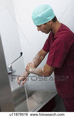 Stock Photograph - Surgeon scrubbing hands. Fotosearch