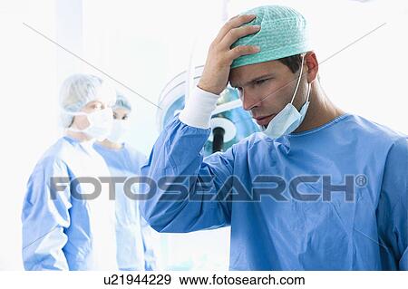 Surgeon under stress in operating room View Large Photo Image Stock Photo - Surgeon under stress in operating room. Fotosearch