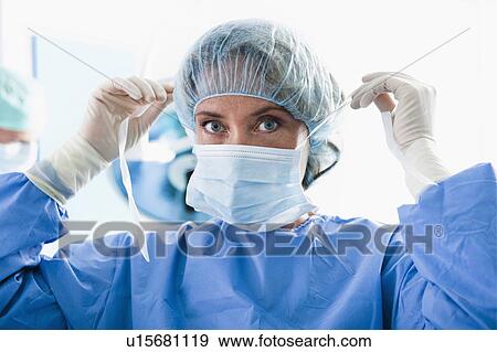 Surgeon wearing surgical mask in operating room View Large Photo Image Stock Photo - Surgeon wearing surgical mask in operating room. Fotosearch