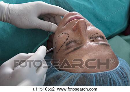 Surgeon's hand with scalpel to patient's face View Large Photo Image Stock Image - Surgeon's hand with scalpel to patient's face. Fotosearch