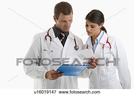 Stock Photo - Two doctors looking at medical chart. Fotosearch