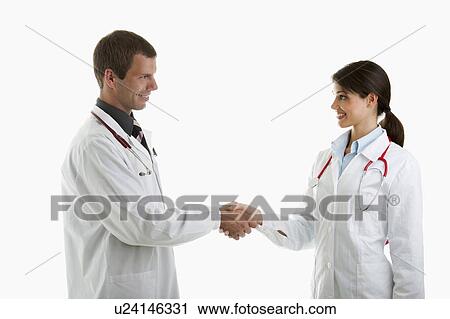 Stock Image - Two doctors shaking hands. Fotosearch