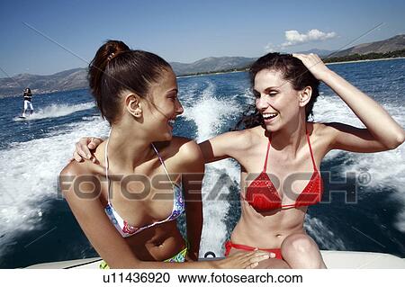 Two female young adults on speedboat View Large Photo Image Stock Image - Two female young adults on speedboat. Fotosearch