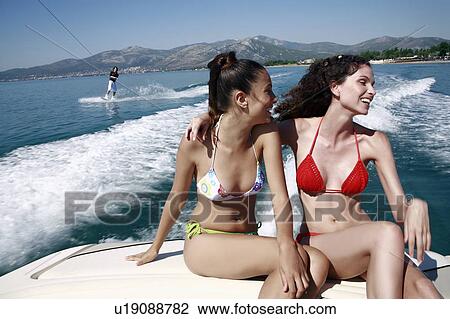 Two female young adults on speedboat View Large Photo Image Stock Image - Two female young adults on speedboat. Fotosearch