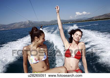 Two female young adults on speedboat View Large Photo Image Stock Image - Two female young adults on speedboat. Fotosearch