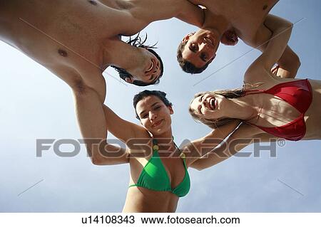 Two male and two female young adults embracing View Large Photo Image Stock Image - Two male and two female young adults embracing. Fotosearch