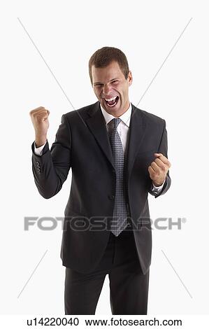 Stock Image - Victorious man holding fists up and shouting. Fotosearch