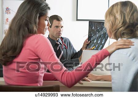 Woman consoling patient at doctor's visit View Large Photo Image Stock Image - Woman consoling patient at doctor's visit. Fotosearch