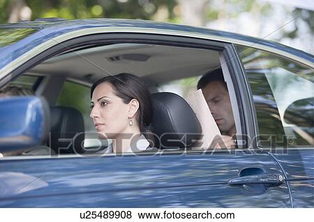Woman driving car with two other people View Large Photo Image Stock Photo - Woman driving car with two other people. Fotosearch