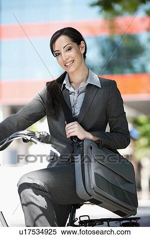 Woman in suit on bicycle View Large Photo Image Stock Photography - Woman in suit on bicycle. Fotosearch