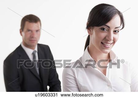 Stock Image - Woman with man in background. Fotosearch
