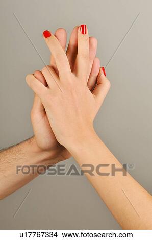 Picture - Young adult couple holding hands. Fotosearch