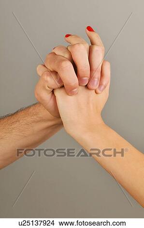 Picture - Young adult couple holding hands. Fotosearch
