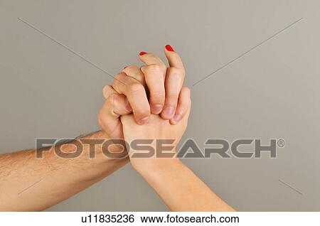 Stock Photograph - Young adult couple holding hands. Fotosearch