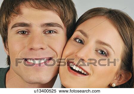 Stock Photography - Young adult couple smiling. Fotosearch