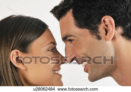 Picture - Young adult couple touching noses. Fotosearch