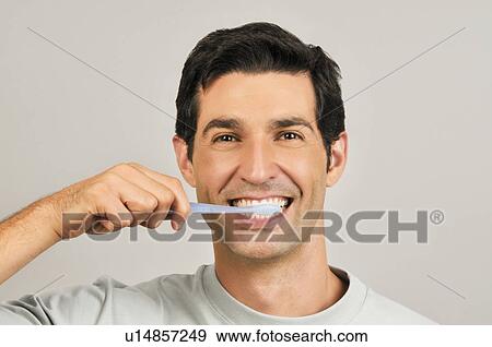 Young male adult brushing teeth View Large Photo Image Stock Photo - Young male adult brushing teeth. Fotosearch