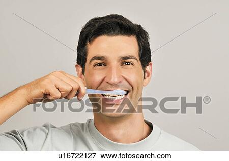 Young male adult brushing teeth View Large Photo Image Stock Photo - Young male adult brushing teeth. Fotosearch