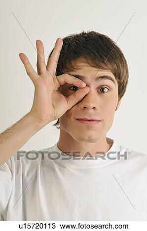 Stock Image - Young male adult cutting finger nails. Fotosearch