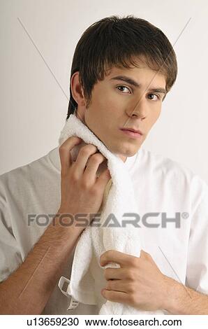 Young male adult drying chin with towel View Large Photo Image Stock Image - Young male adult drying chin with towel. Fotosearch