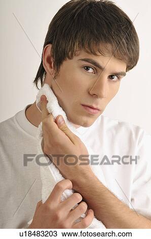 Young male adult drying chin with towel View Large Photo Image Stock Image - Young male adult drying chin with towel. Fotosearch