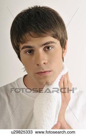 Young male adult drying chin with towel View Large Photo Image Stock Image - Young male adult drying chin with towel. Fotosearch