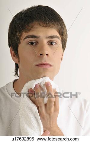 Young male adult drying chin with towel View Large Photo Image Stock Photography - Young male adult drying chin with towel. Fotosearch