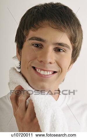 Young male adult drying neck with towel View Large Photo Image Stock Image - Young male adult drying neck with towel. Fotosearch