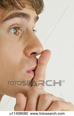 Young male adult; finger to lips View Large Photo Image Stock Image - Young male adult; finger to lips. Fotosearch