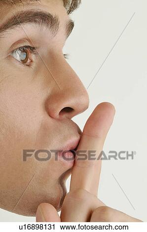 Young male adult; finger to lips View Large Photo Image Stock Image - Young male adult; finger to lips. Fotosearch