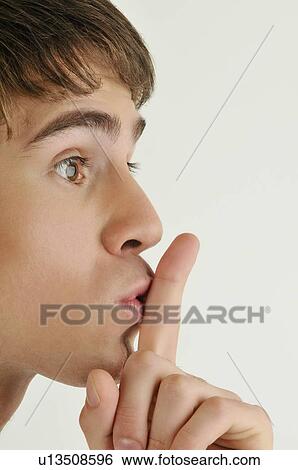 Young male adult; finger to lips View Large Photo Image Stock Photograph - Young male adult; finger to lips. Fotosearch
