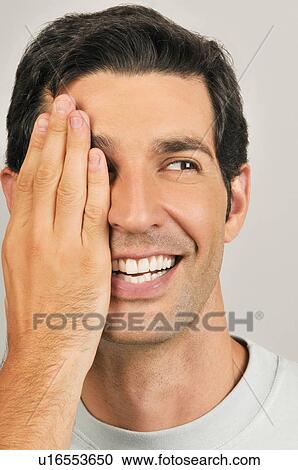 Young male adult; hand covering one eye View Large Photo Image Stock Image - Young male adult; hand covering one eye. Fotosearch