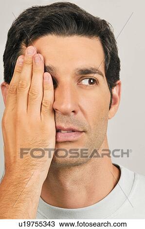 Young male adult; hand covering one eye View Large Photo Image Stock Image - Young male adult; hand covering one eye. Fotosearch