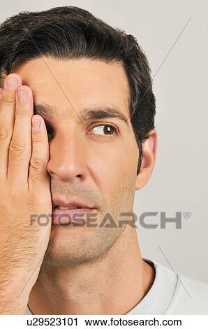 Young male adult; hand covering one eye View Large Photo Image Stock Image - Young male adult; hand covering one eye. Fotosearch