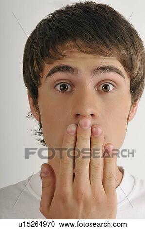 Young male adult; hand to mouth View Large Photo Image Stock Image - Young male adult; hand to mouth. Fotosearch