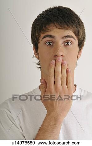 Stock Photo - Young male adult; hand to mouth. Fotosearch