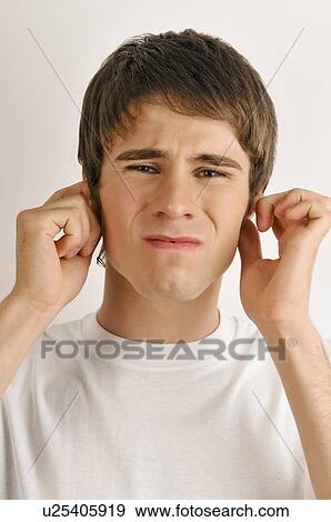 Young male adult holding ears View Large Photo Image Stock Photo - Young male adult holding ears. Fotosearch