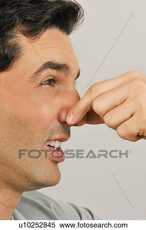 Young male adult holding nose View Large Photo Image Stock Photography - Young male adult holding nose. Fotosearch