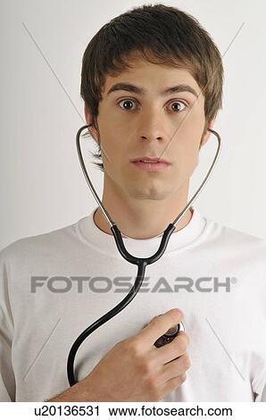 Young male adult; listening to his heart with stethoscope View Large Photo Image Stock Image - Young male adult; listening to his heart with stethoscope. Fotosearch